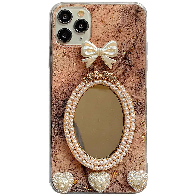 Brown marble pattern bowknot rhinestone mirror silicone case on an iPhone.