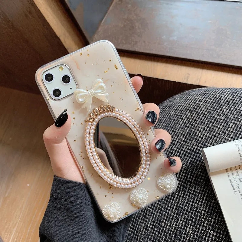 Brown marble pattern bowknot rhinestone mirror silicone case on an iPhone.