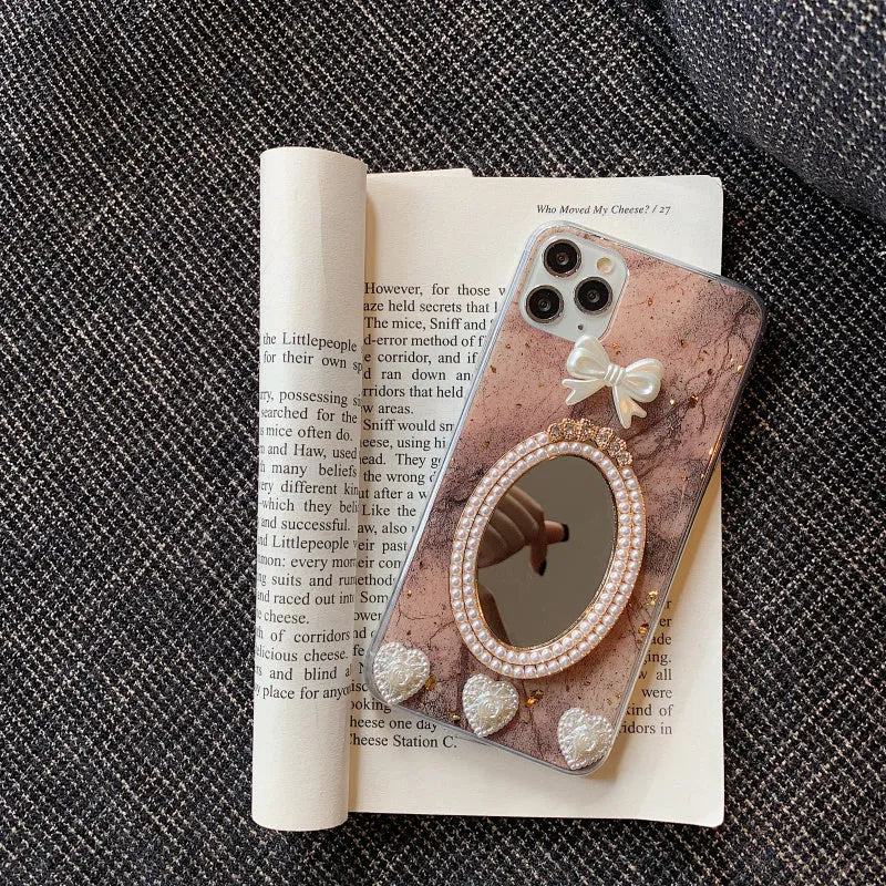 Brown marble pattern bowknot rhinestone mirror silicone case on an iPhone.