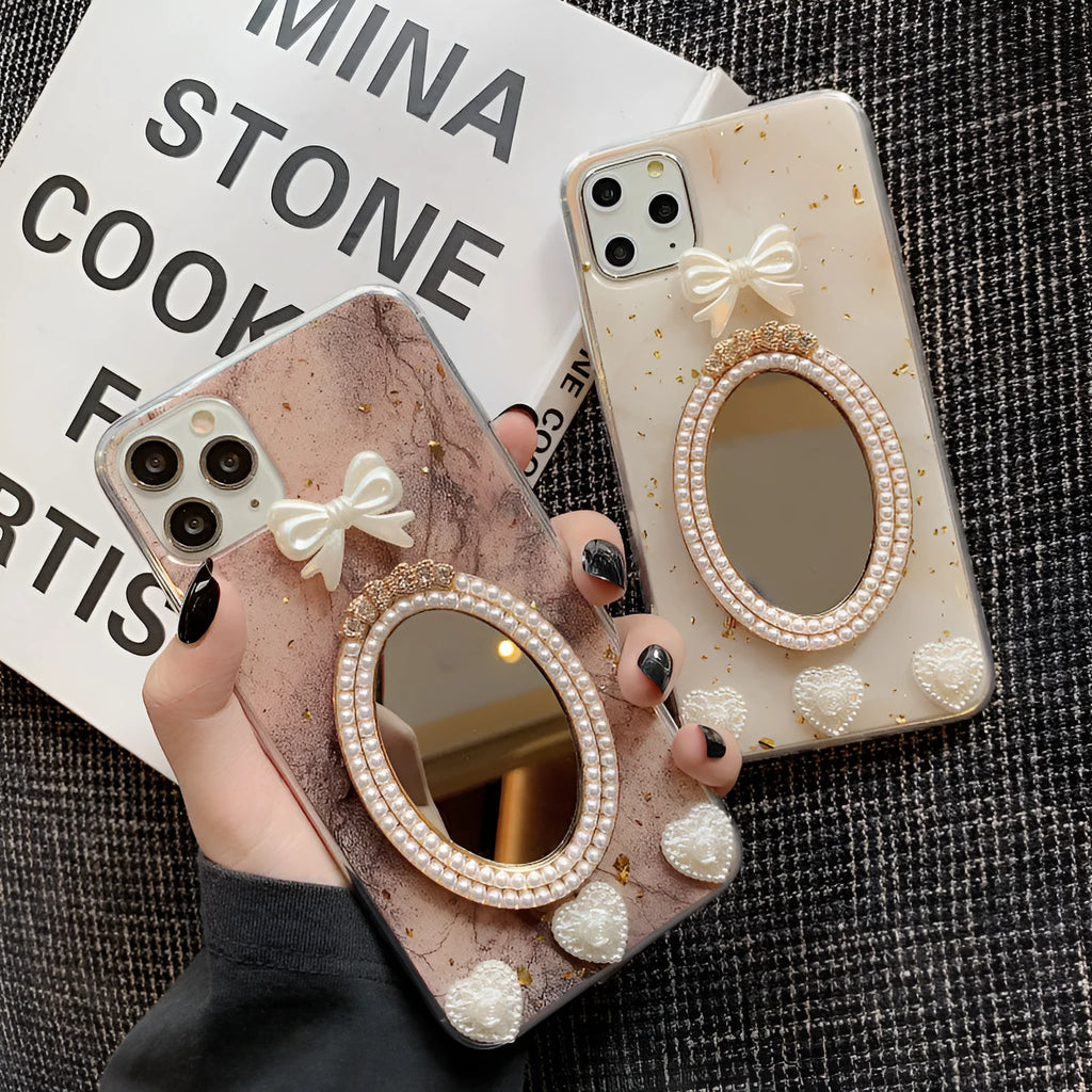 Brown marble pattern bowknot rhinestone mirror silicone case on an iPhone.