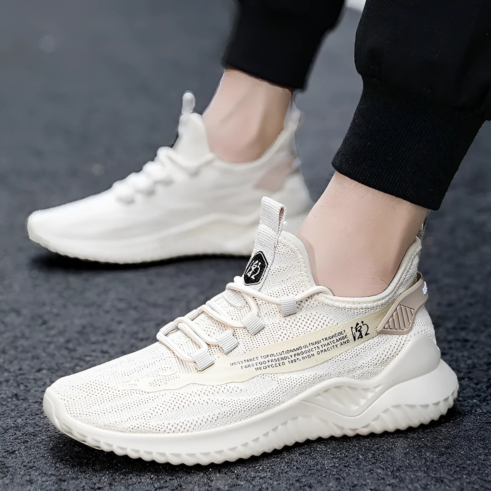 Men's white low-top sports shoes with mesh uppers and rubber soles displayed from side angle