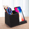Black leather wireless charging desk organiser with pen holder and phone stand at 45-degree angle