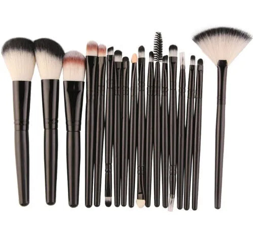 18-piece makeup brush set with fan brushes arranged on a table.