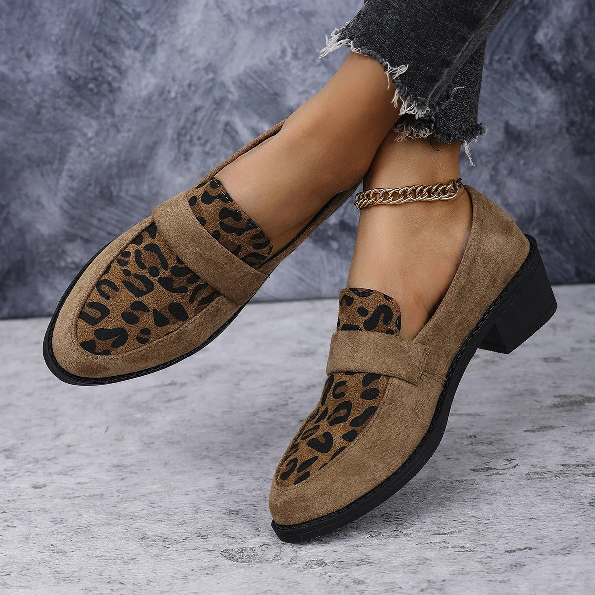 Leopard print suede slip-on pump with chunky heel in brown, shown from the side.