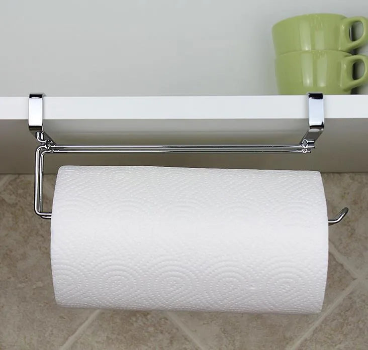 Silver stainless steel paper towel rack mounted on a kitchen cabinet door