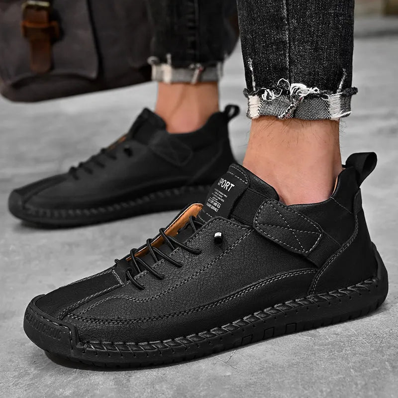 Men's mid-calf black Martin boots with tooling stitching and a flat rubber sole on a white background.