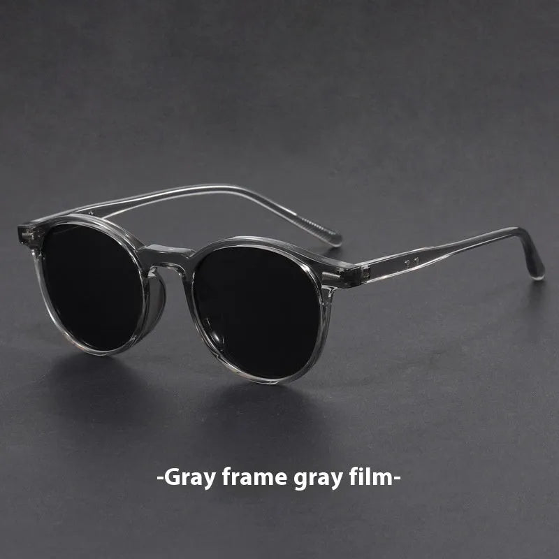Retro oval sunglasses with ultra-lightweight round frame and polarised grey lenses.