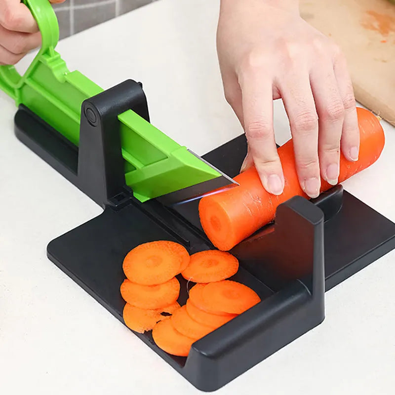 Green and red modern vegetable cutter with stainless steel blades for slicing carrots and potatoes.