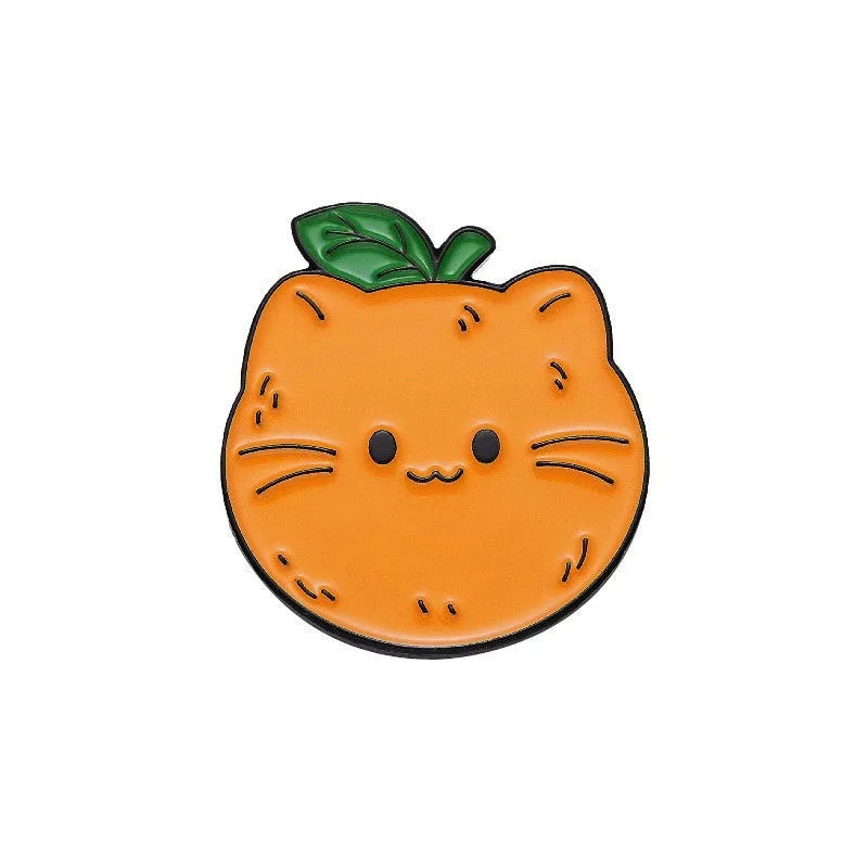 Colourful cartoon fruit design metal brooch with pin back on a fabric background.