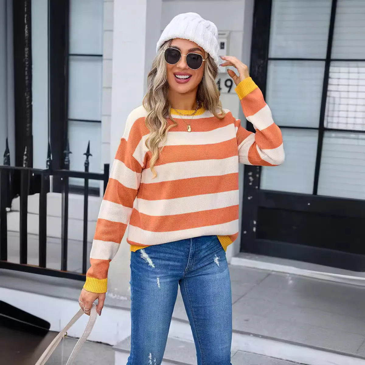 Women's loose long sleeve acrylic sweater in blue with stripes, round neck.