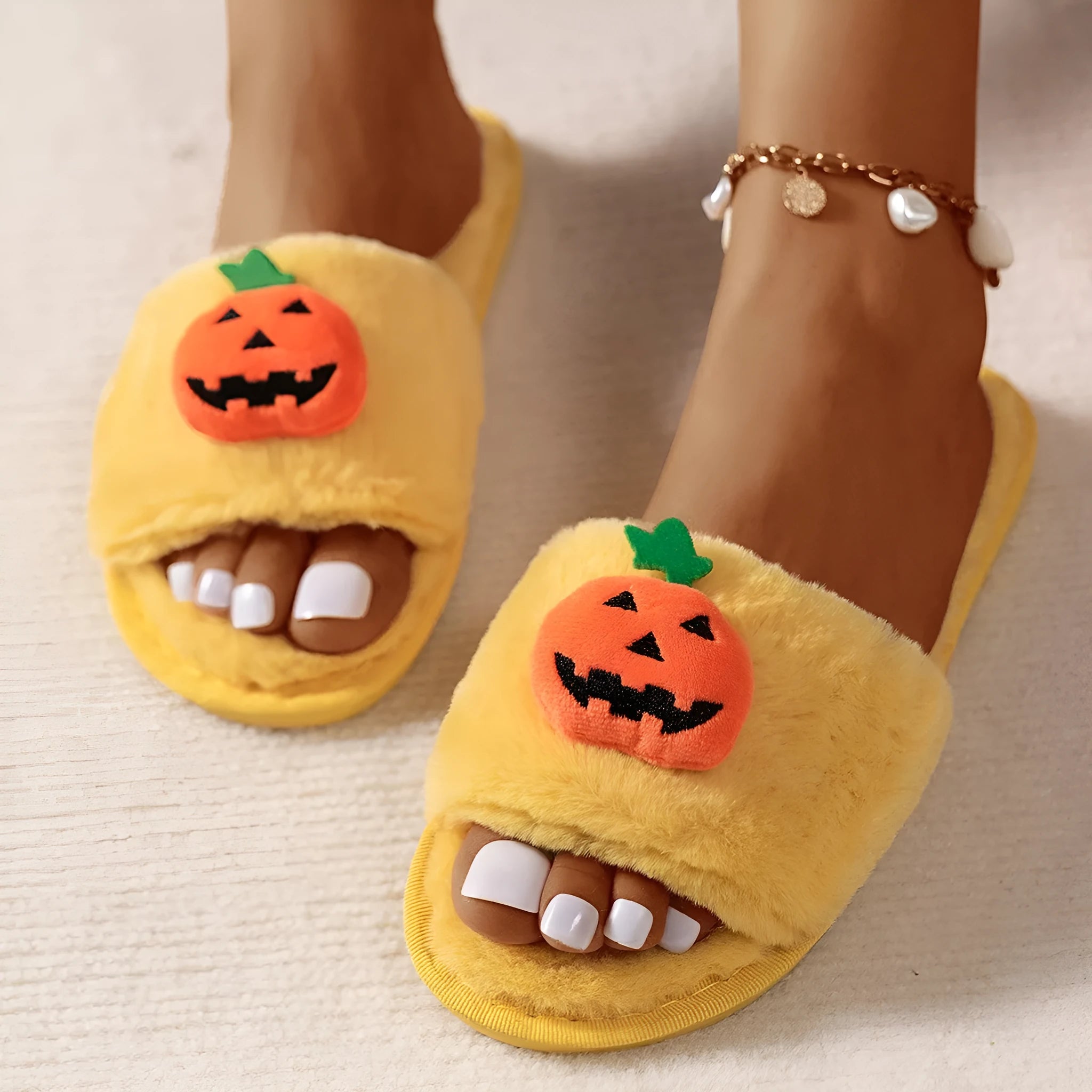 White and yellow Halloween pumpkin plush open toe slippers on anti-slip PVC sole.