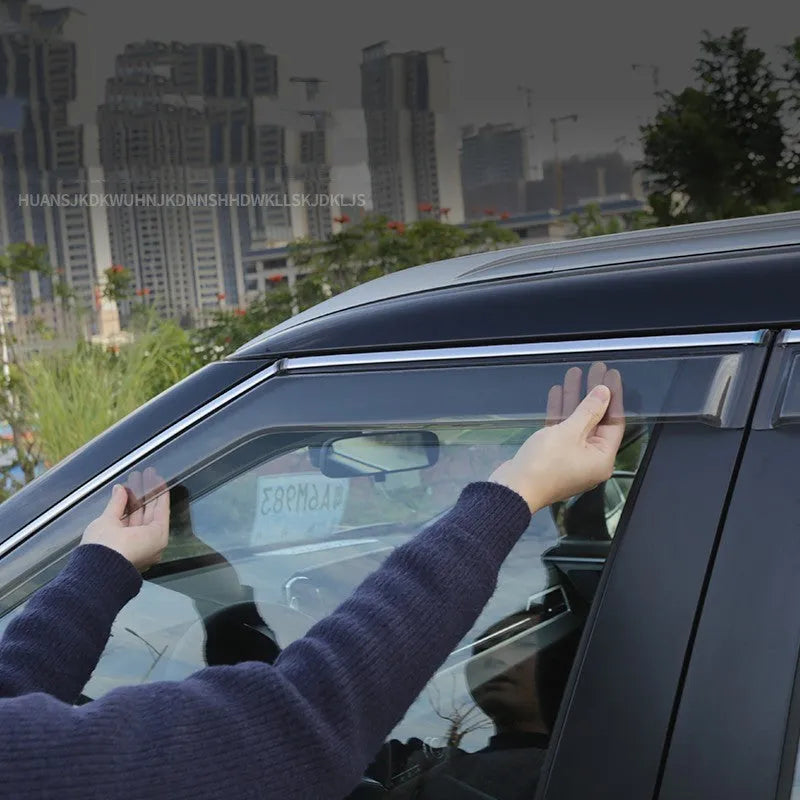 Black Warrior and translucent window deflector sets for a 2023 Mitsubishi Outlander.