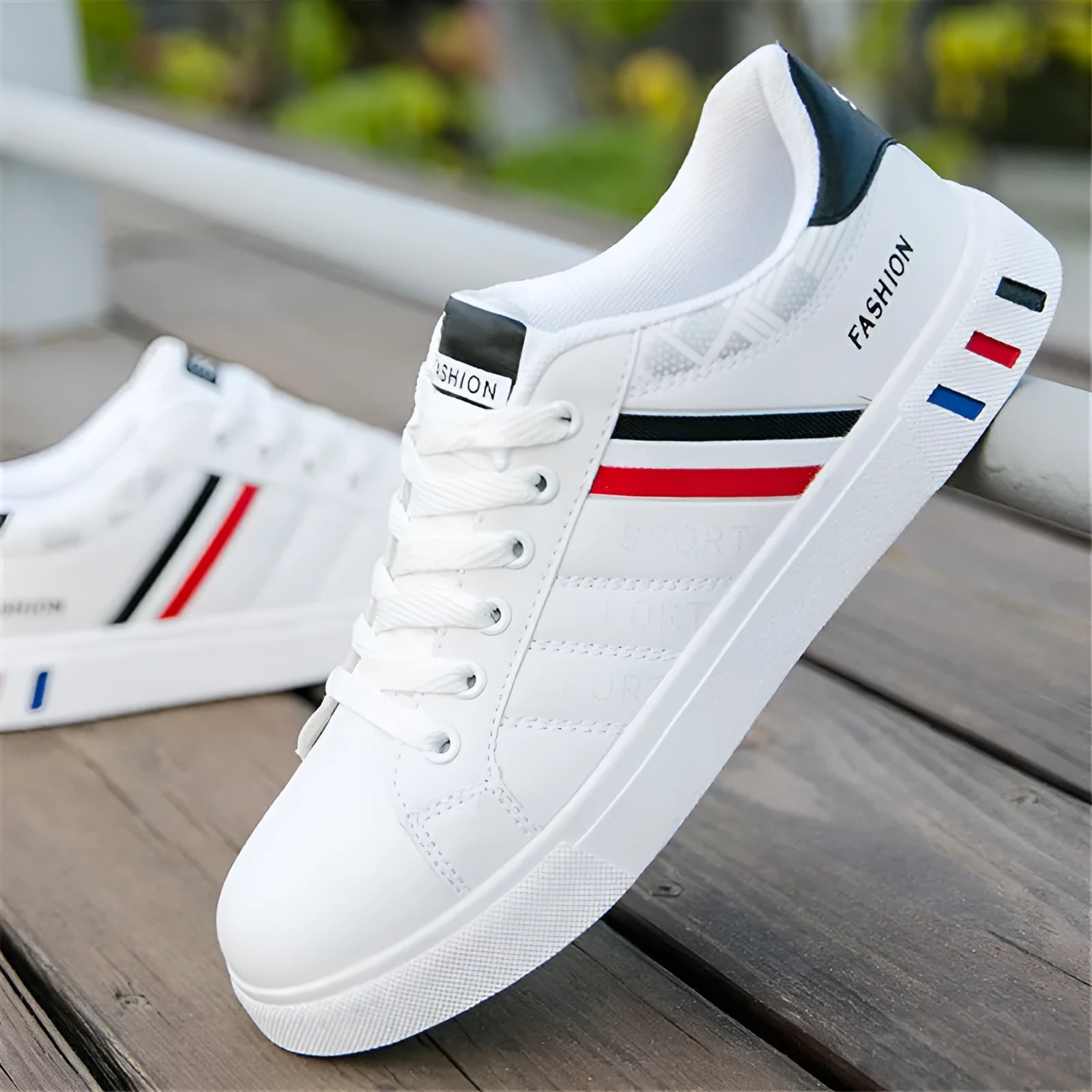 A pair of sports shoes on a white background, shown in black, grey, or white colour options.