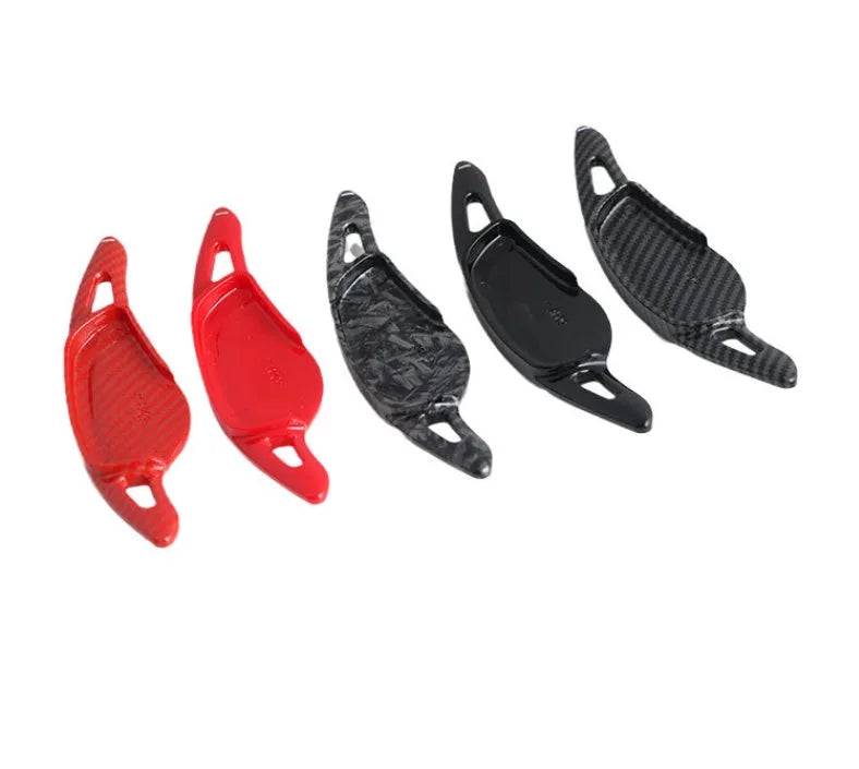 Steering wheel paddle shifter modification kit with carbon fibre pattern on black background