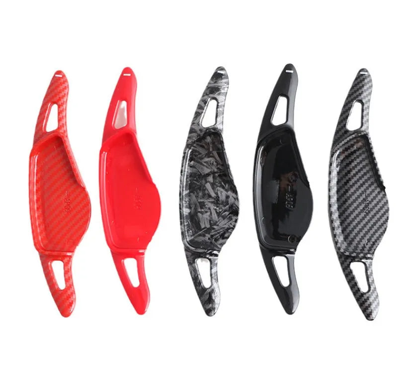 Steering wheel paddle shifter modification kit with carbon fibre pattern on black background