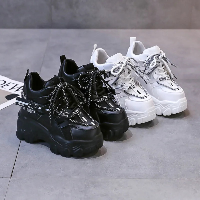 White women's low-top platform sports shoes with breathable mesh, cross strap, and rubber sole.