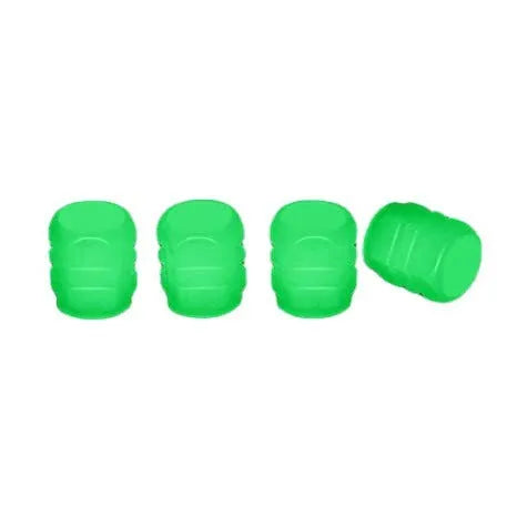 Pack of green and blue luminous rubber tyre valve caps on a car tyre valve.