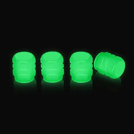 Pack of green and blue luminous rubber tyre valve caps on a car tyre valve.