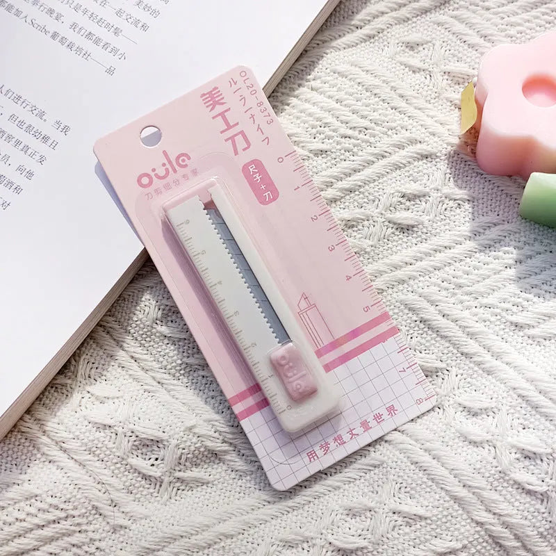 Small art knife in five colours with plastic blade measuring 7.2cm for package cutting