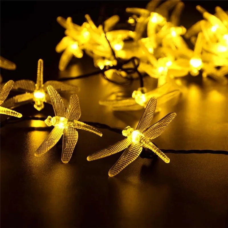 Outdoor solar LED string light with 30 warm white dragonfly lights and solar panel with ground spike