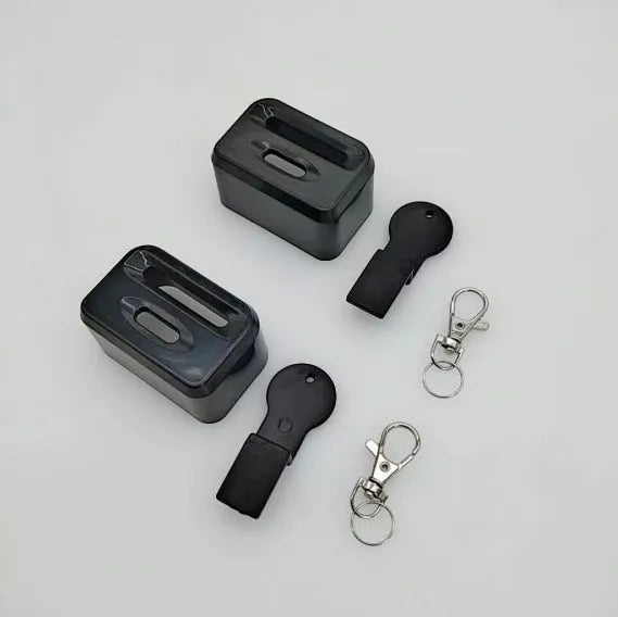 Black and red plastic seat belt buckle protective clamp holder device on a car seat.