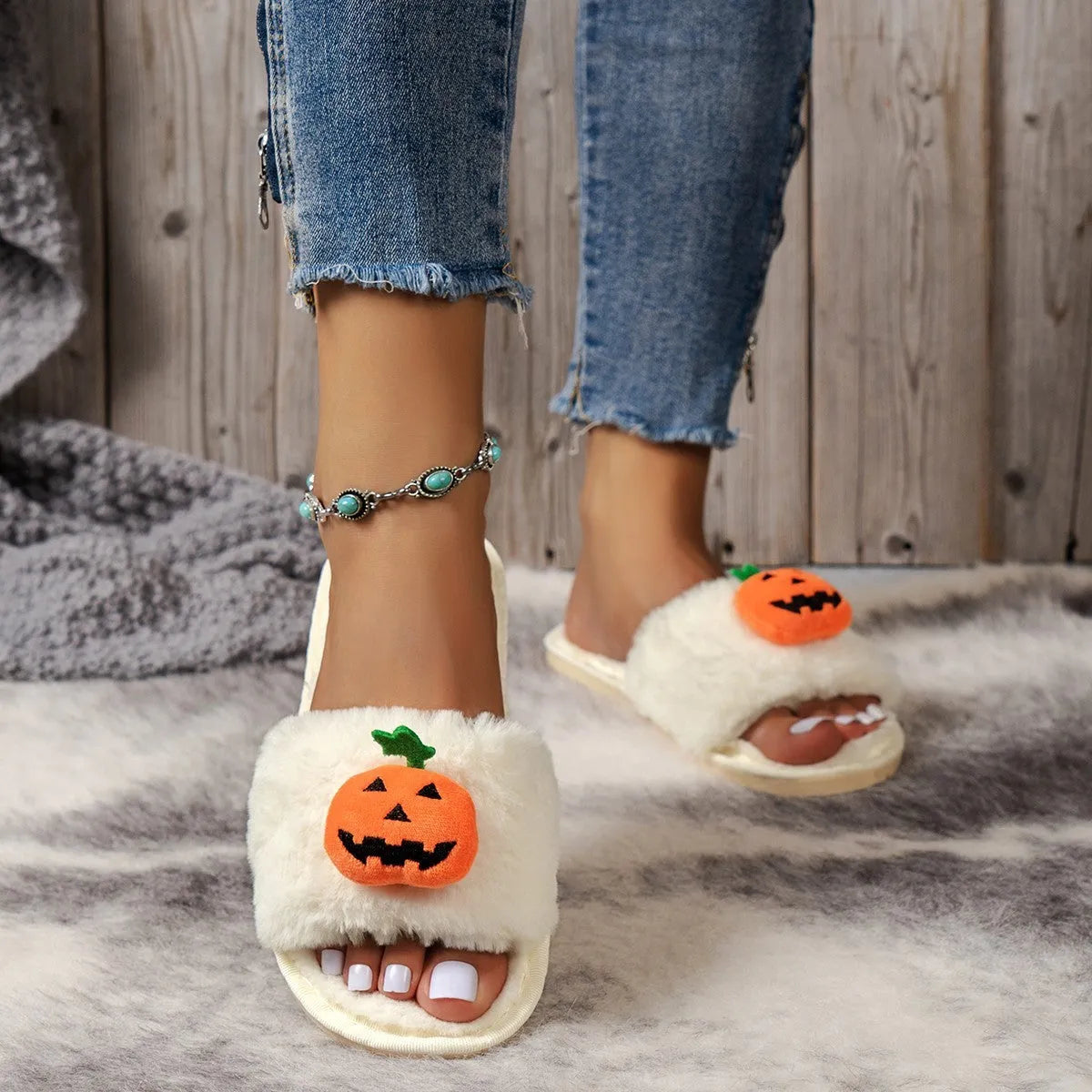 White and yellow Halloween pumpkin plush open toe slippers on anti-slip PVC sole.