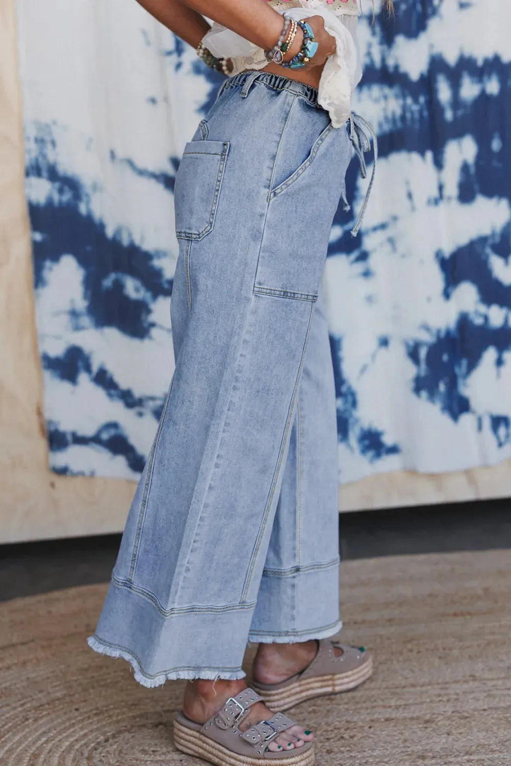 Beau Blue wide leg denim pants with drawstring waist and raw hem detailing laid flat