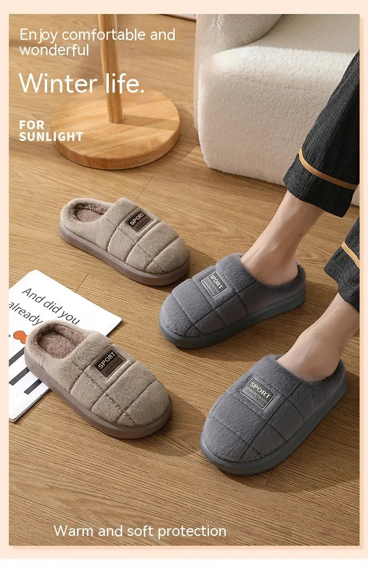 Men's grey plaid rabbit hair slippers with a thick sole, shown on a wooden floor.