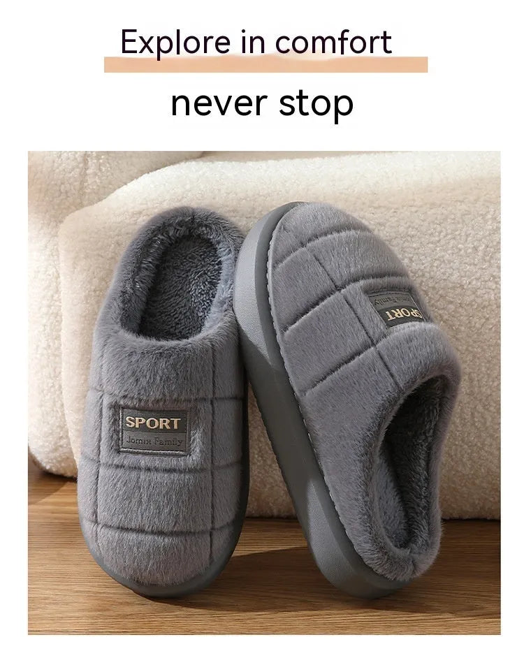 Men's grey plaid rabbit hair slippers with a thick sole, shown on a wooden floor.