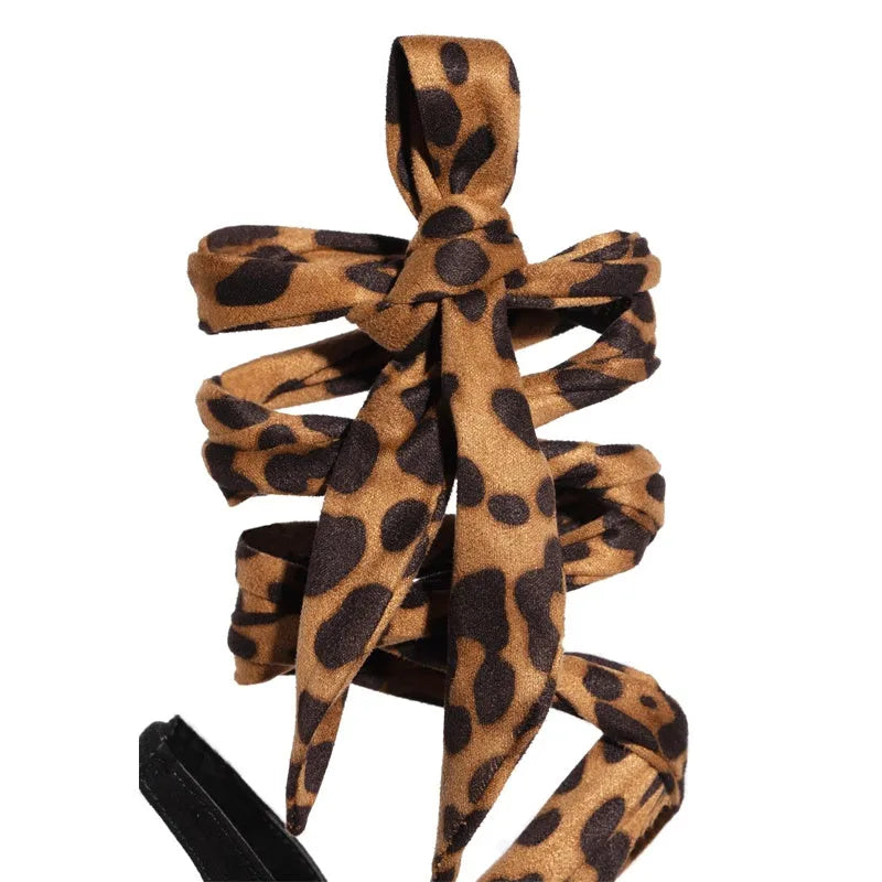 Light brown leopard print high heel shoes with cross straps and super high heel