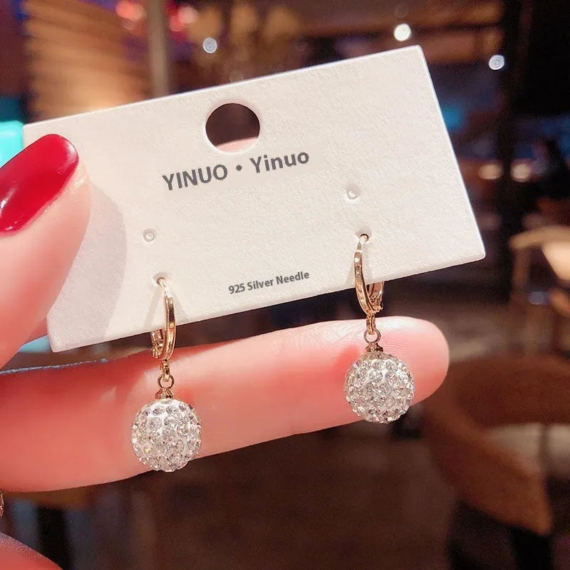 A pair of women's geometric copper earrings with a rose design and small zircon stone accents.