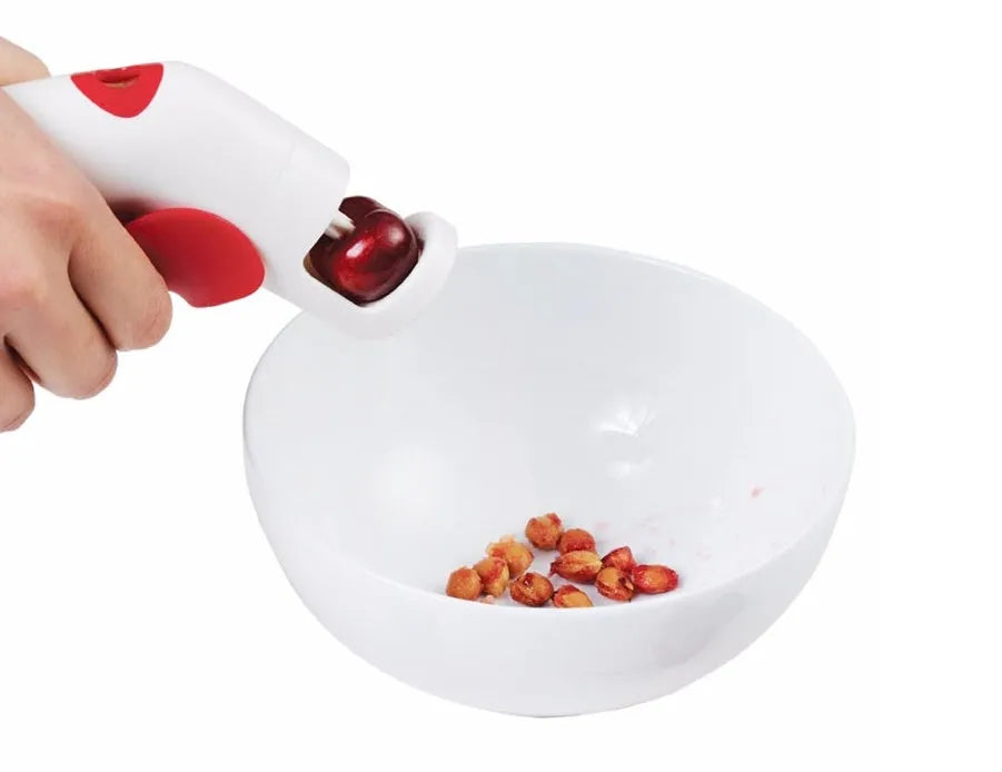 Stainless steel manual cherry kernel remover tool with ergonomic handle and spare pins.