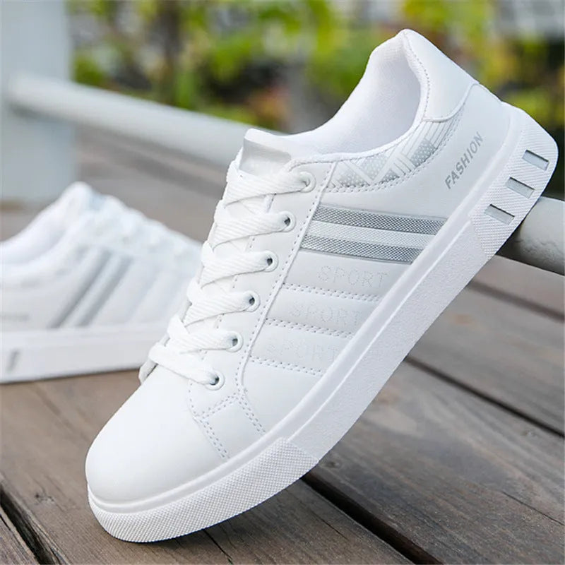 A pair of sports shoes on a white background, shown in black, grey, or white colour options.