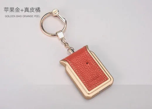 Black leather Bluetooth dual SIM adapter keychain for iOS phones with micro USB port.