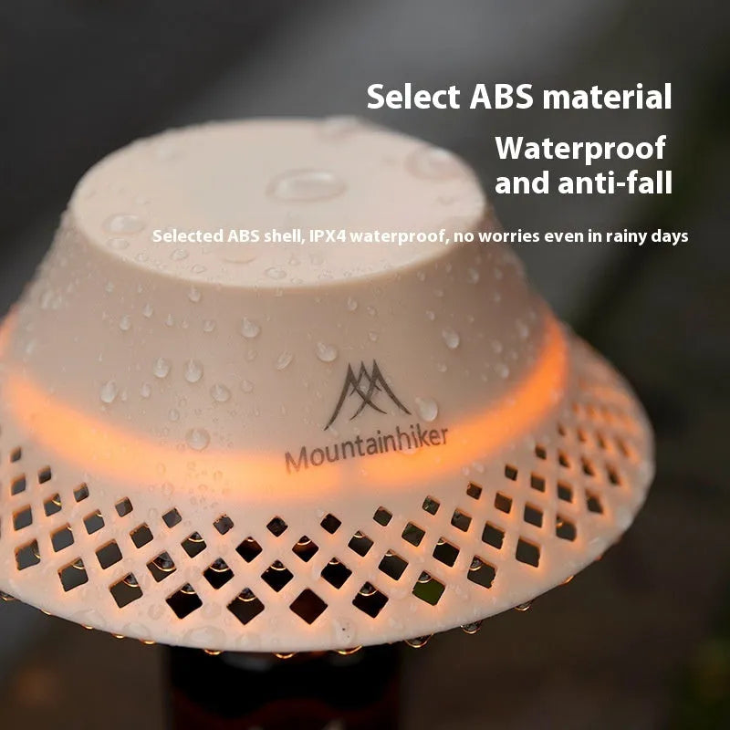 Beige wine bottle shaped camping lantern with USB-C port shown on a table.