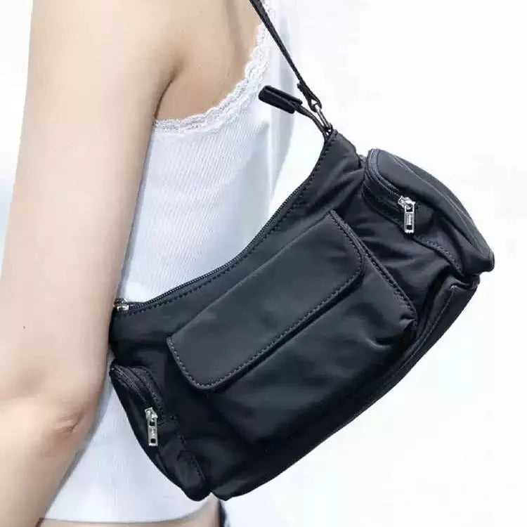 Black lightweight women's shoulder bag made of PU leather with double pockets and side line details.