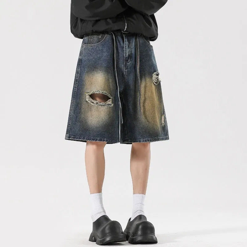 American High Street men's loose fit ripped jeans in retro blue denim showing distressed detail.