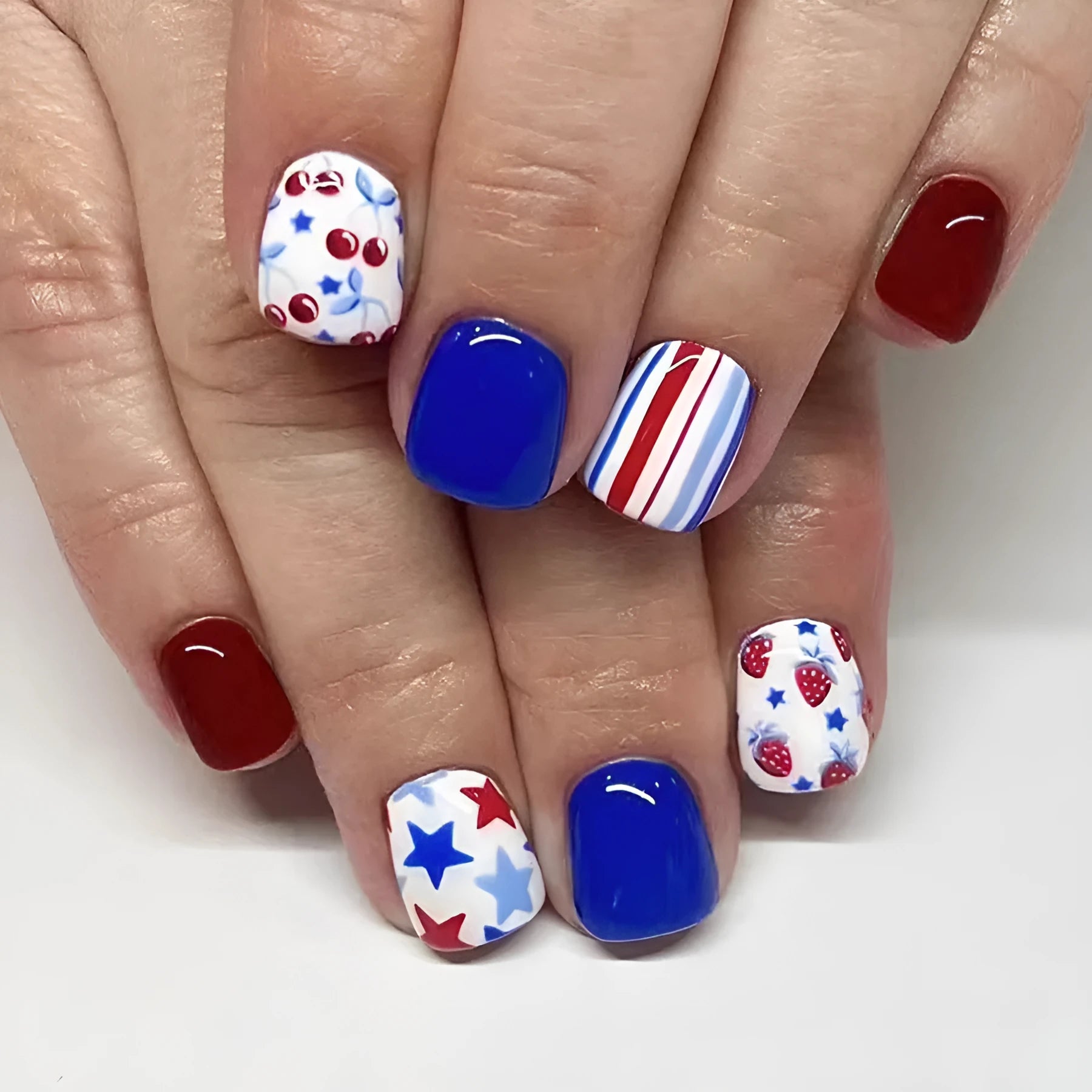 Short glossy false nail stickers with red and blue strawberry cherry design for Independence Day