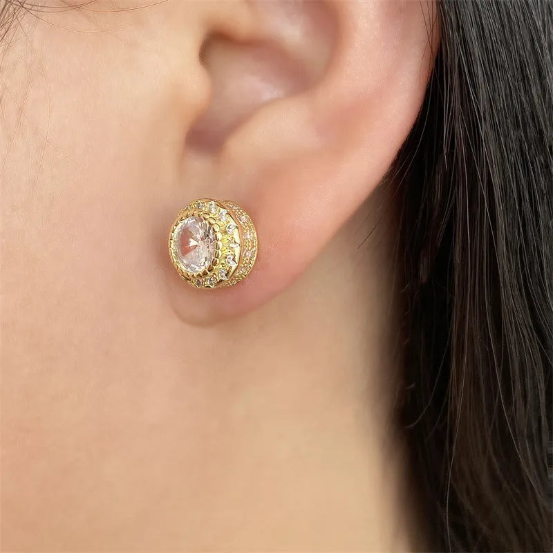 Round copper stud earrings with inlaid zircon in gold tone on white background