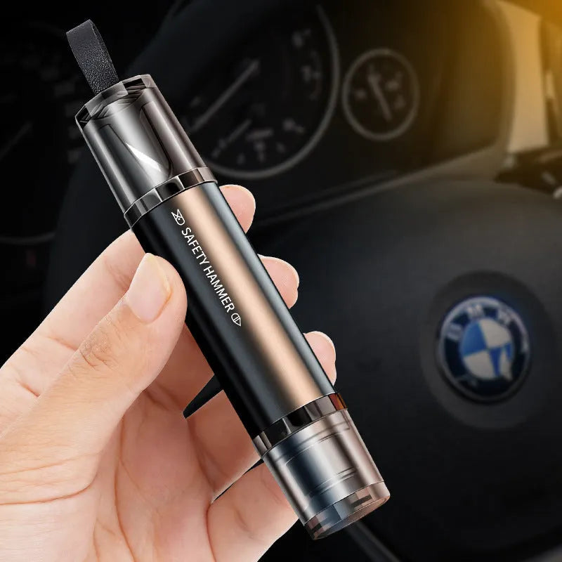 Black and red aluminium alloy car emergency hammer with tungsten steel tip and integrated seat belt cutter on a mounting base.