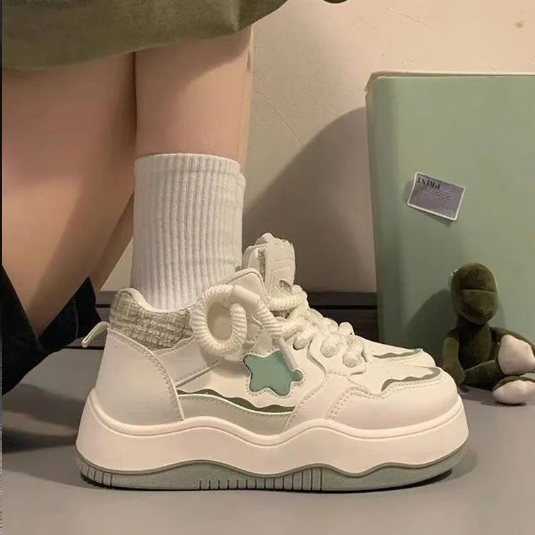 Women's green and pink patent leather platform sneakers with round toe and lace-up closure