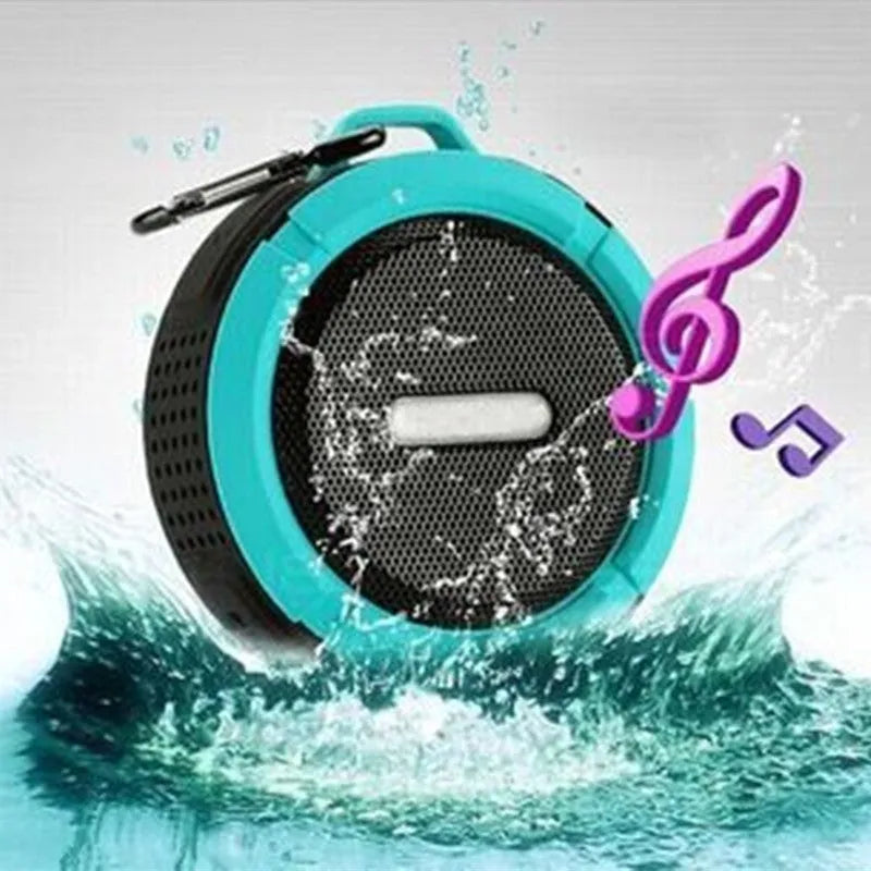 Portable waterproof Bluetooth speaker in multiple colours with a mountaineering buckle for bag attachment.