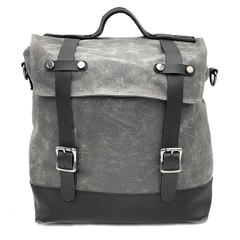 Waterproof canvas motorcycle side pannier bag in black mounted to motorcycle