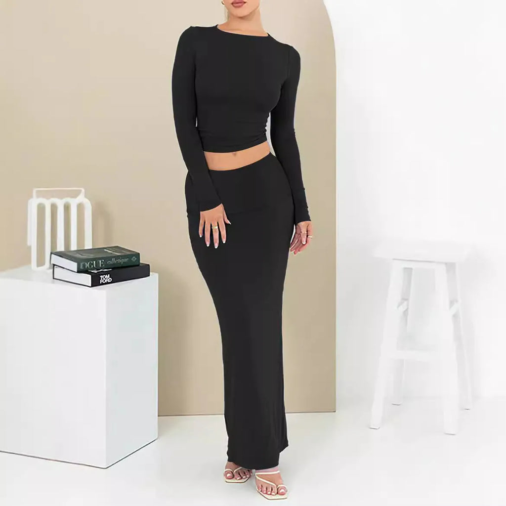Women's black polyester two-piece suit with waist-exposing top and long skirt