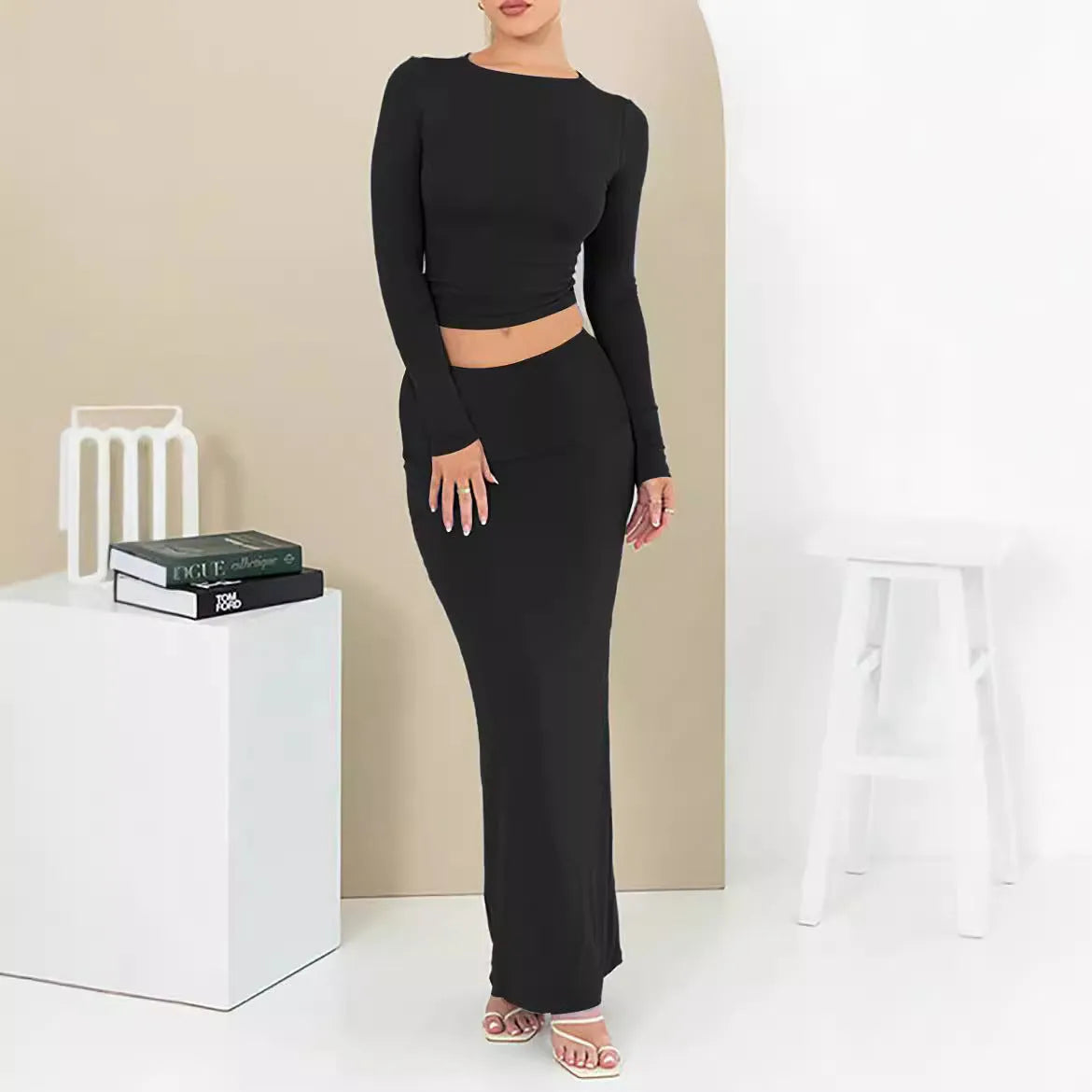 Women's black polyester two-piece suit with waist-exposing top and long skirt