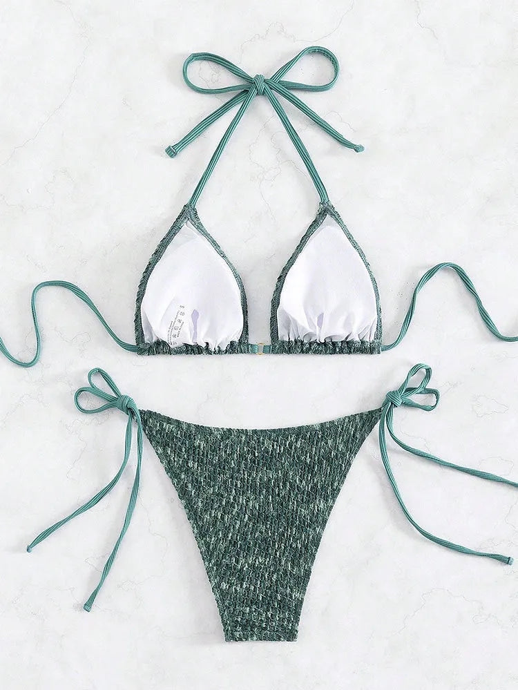 Women's green halter strap backless swimsuit set with three-point design and matching shorts