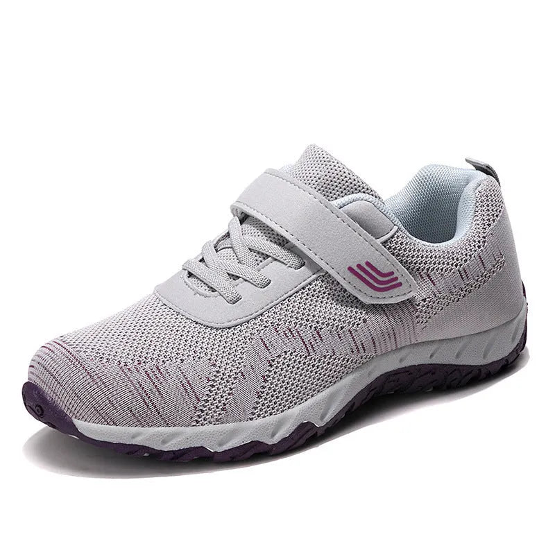 Women's low-top sneakers with Velcro straps and a wedge heel, in a mesh upper and solid colour.