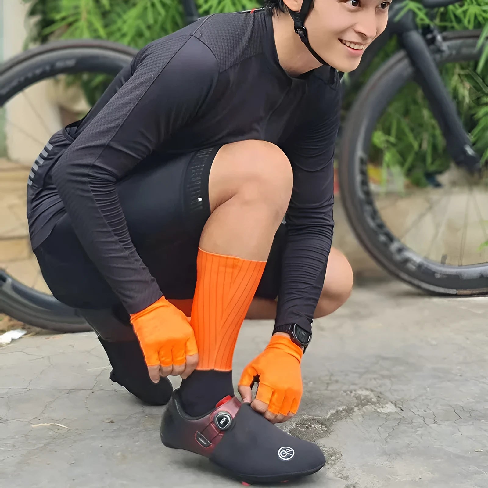 Pair of breathable chemical fibre blend athletic socks for cycling and running, shown in orange colour.
