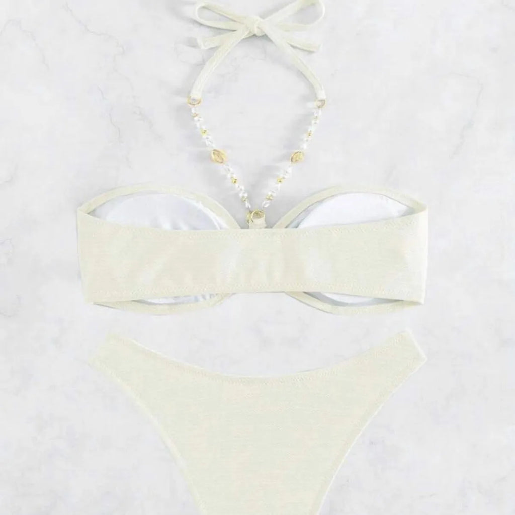 Women's solid colour halter bikini set on a mannequin, showing the halter top and briefs.