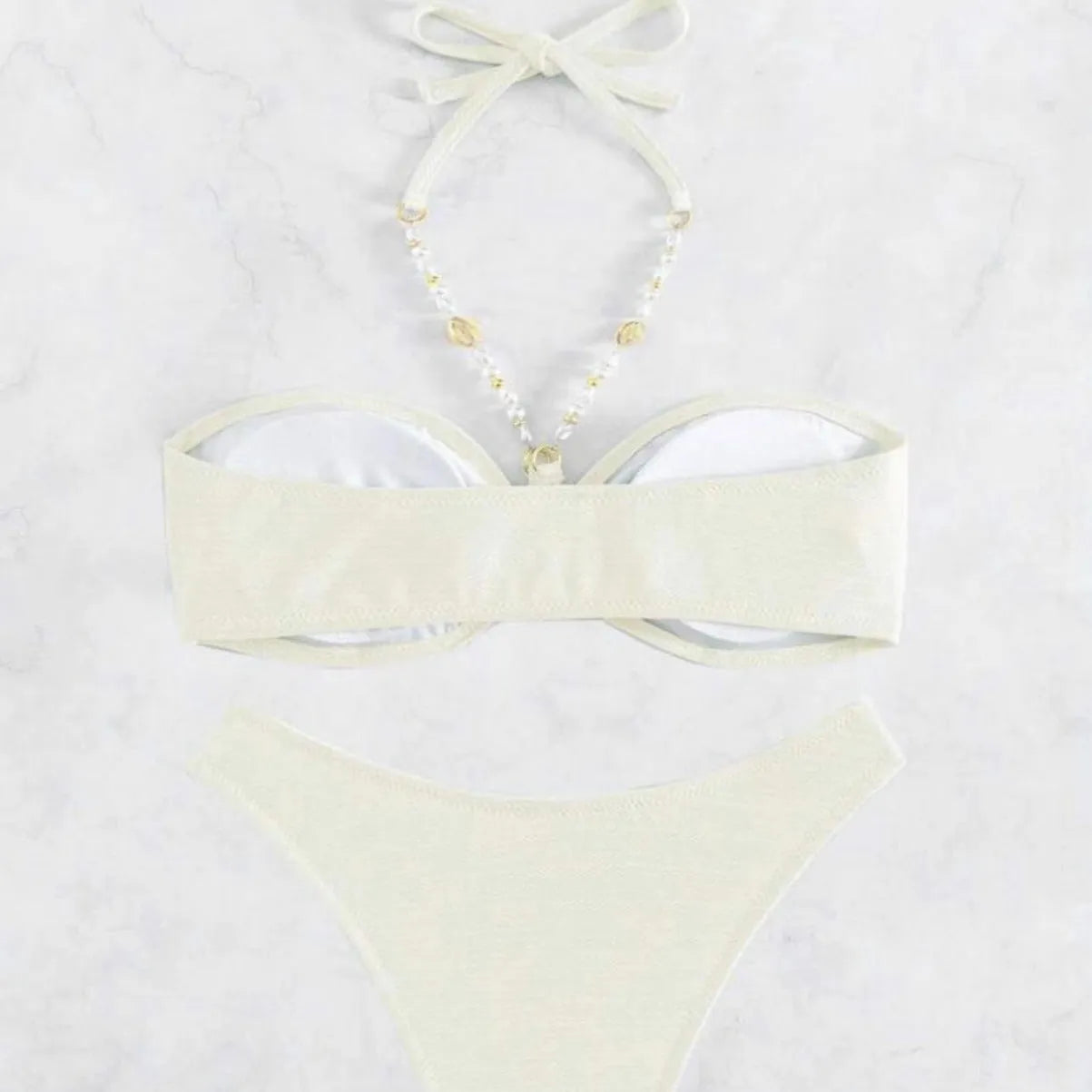 Women's solid colour halter bikini set on a mannequin, showing the halter top and briefs.